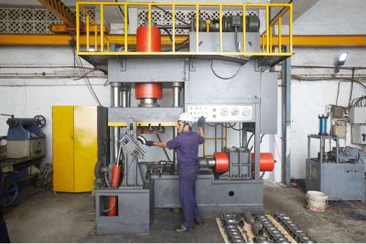 Operator working at a large industrial press