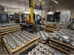Machinery and trays of flanges on the workshop floor