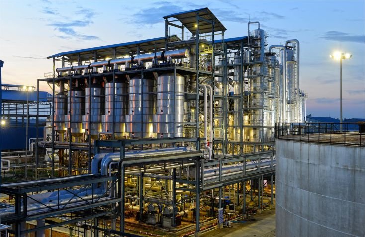 Industrial processing plant with vessels, pipework and access platforms